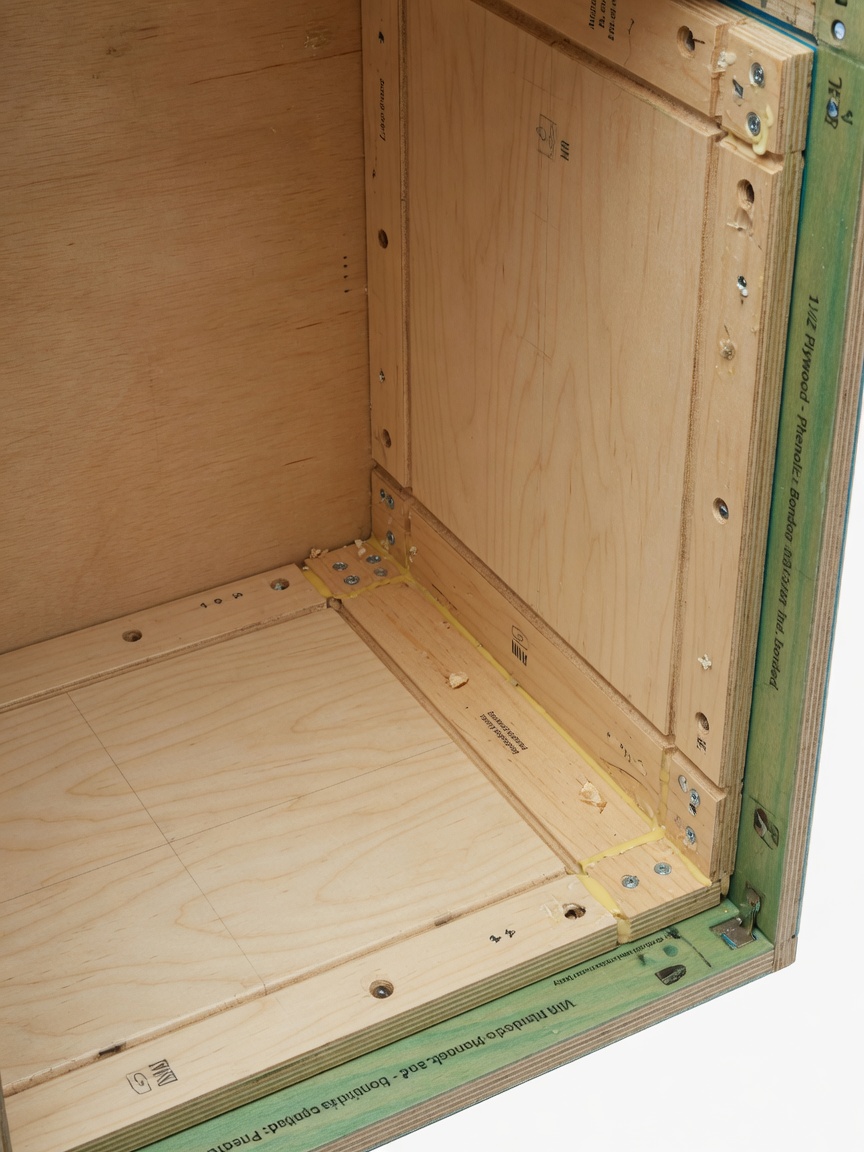 Close-up 8K image of plywood cabinet box construction with visible captured bottom and back panels, highlighting moisture-resistant features and commercial grade joinery, professional product photography with perfect lighting